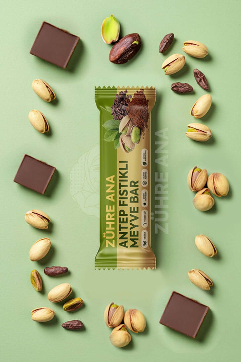 ANTEPL FISTIKLI MEYVE BAR 12 adet with pistachios and chocolate pieces on a green background
